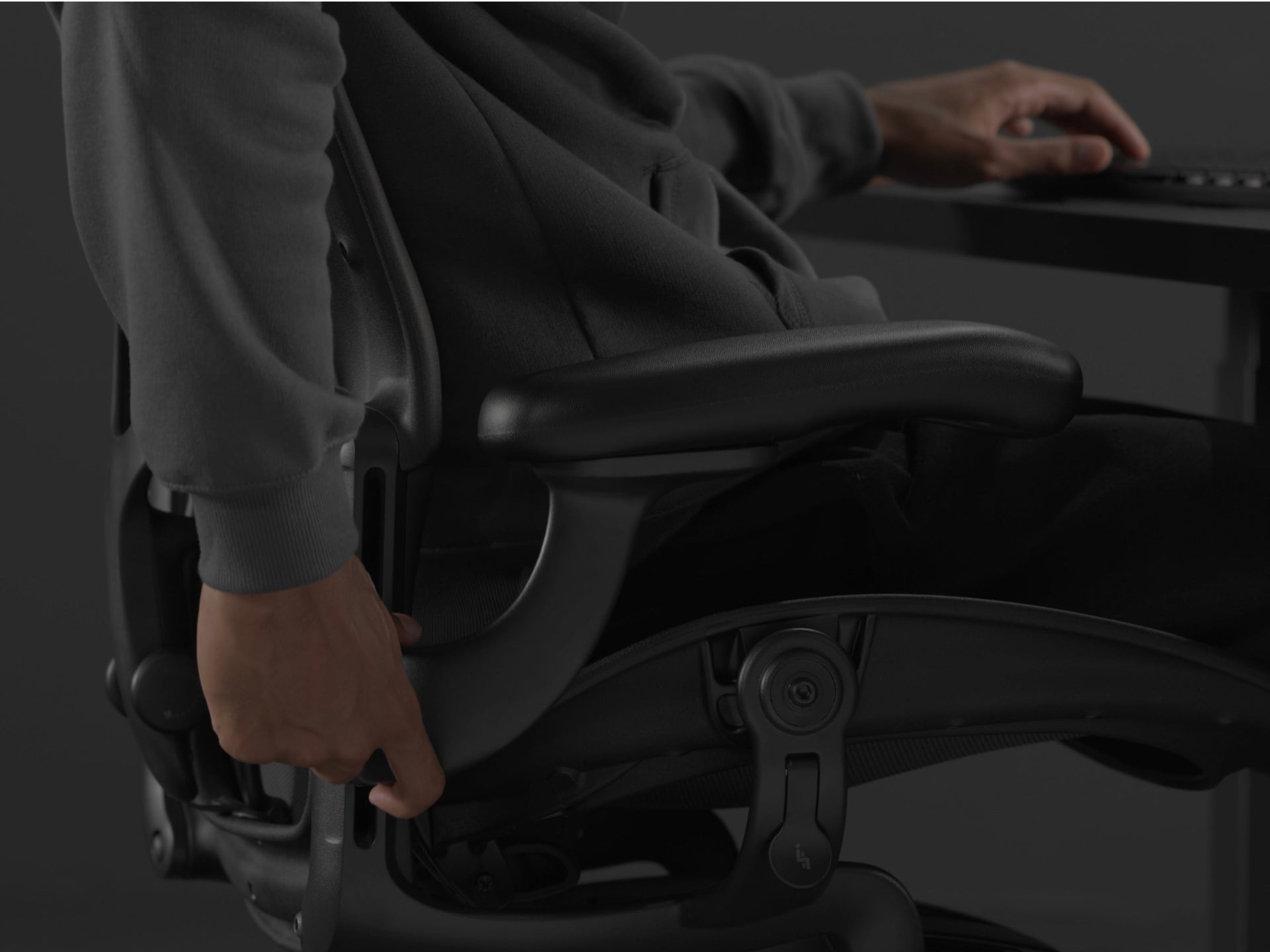A close-up video of a person’s hand adjusting the BackFit on a black Embody Gaming Chair.